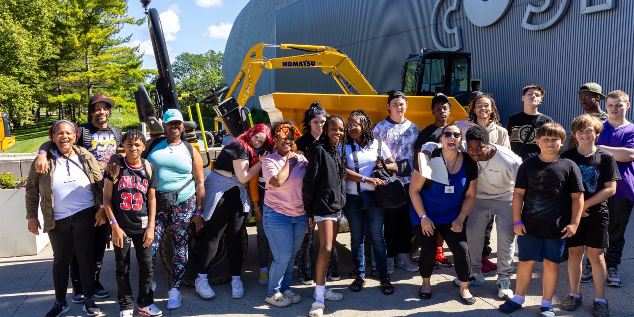 A group of KYS Youth and Staff outside in front of COSI on a field trip